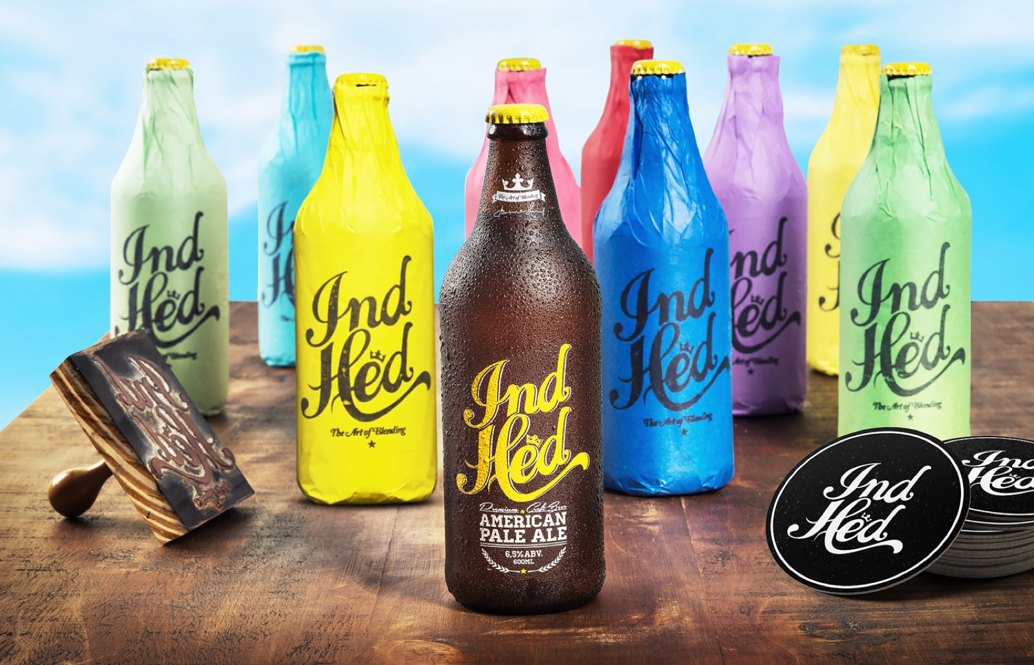 IndHed craft beer bottles in color-rotated wraps with hand-lettered script, by INDUSTRIA