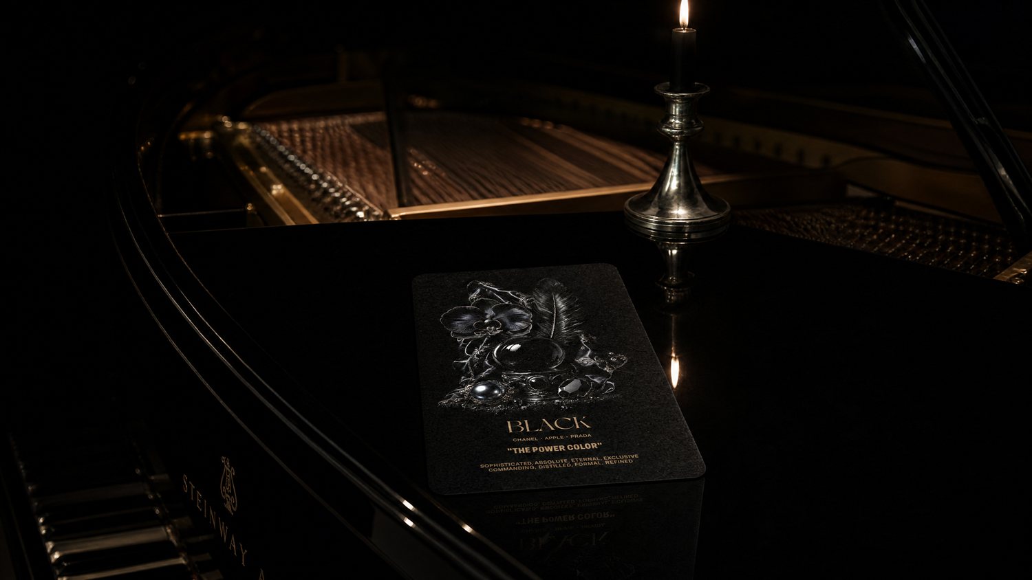 The Black card resting on a grand piano, lit by a single candle